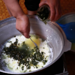 Mixing fresh wild onions (mangir) and curdled cheese